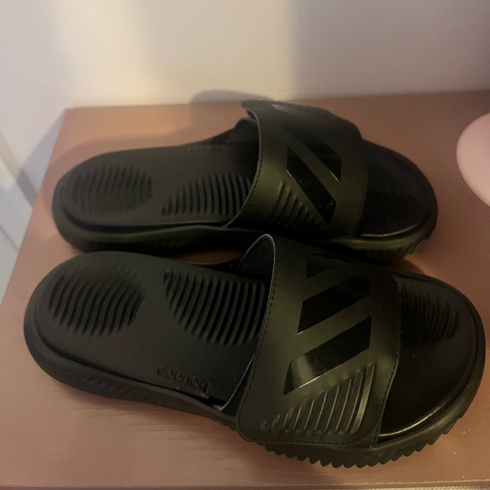 Selling adidas slides.